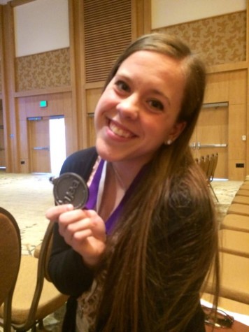 SUPERIOR award in editorial writing for Highlander editor-in-chief Katie Bandurski. Highest award given at Write-offs! She listened to a speaker on water supply and composed on Friday. Katie Bandurski  holds up her medal.