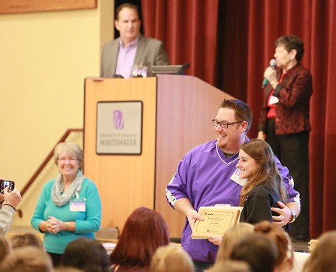 Jeff Willauer presents All-KEMPA award to the Purple Sage newspaper editor from Waunakee High School.